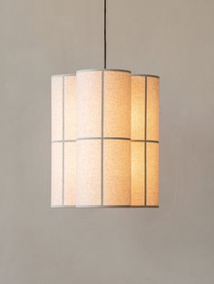 a lamp hanging from a ceiling with white shades