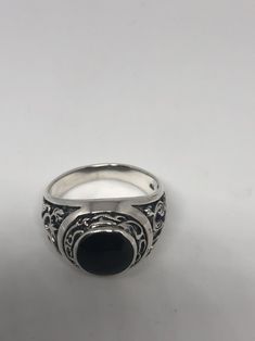 Cool Vintage Rock and Roll star men's ring Nice heavy ring, Sterling silver set with genuine black Onyx Unused stock from the 1970's I have a sizes 8.5, 9.5, 10.75, 11.5, and 12.75 These can be resized by my jeweler for a $10 fee Please add your size to the order in a message and I will send the size you require. All jewelry is shipped in a nice gift box. Check out our over a THOUSAND great reviews Engraving is $4 per letter and is not always perfect depending on the piece. It can take a few day Black Gothic Collectible Rings, Vintage Black Onyx Signet Ring, Vintage Black Sterling Silver Signet Ring, Gothic Black Ring Stamped 925, Vintage Black Round Signet Ring, Black Vintage Engraved Ring With Polished Finish, Vintage Black Engraved Round Ring, Black Sterling Silver Signet Ring For Collectors, Vintage Black Engraved Ring Stamped 925