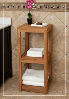 a wooden shelf with towels and a sink in a bathroom next to a tiled wall