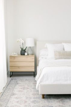 a bedroom with a white bed and two nightstands