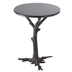 a round table with tree branches on the top and bottom, against a white background