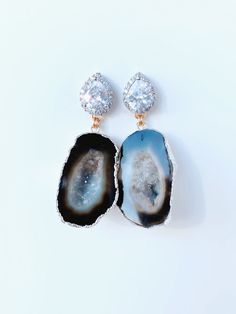 Meet, Gemma. One of our Signature styles. She features a Silver CZ post with a geode that is set in 24kt gold or silver. She can be customized and comes in other colors too. Please note, each geode is beautiful and unique. This is what makes each pair so special. Each stone is similar, but not exact. Please contact us directly to see images of the actual stone. CZ is also available in Rose Gold. Dimensions: 2” Luxury Agate Wedding Jewelry, Unique Silver Gemstone Geodes, Unique Silver Geode With Gemstone Details, Unique Silver Geode Gemstones, Elegant Agate Jewelry With Gemstone Accents, Unique Handmade Gold Geodes, Gold Agate Jewelry For Wedding, Elegant Jewelry With Gemstone Accents And Mineral Crystal, Unique Round Gemstone Geodes