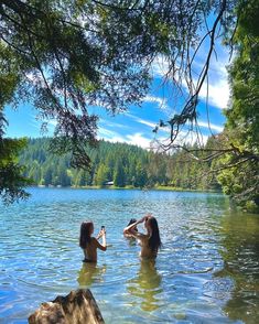 two women are in the water drinking wine