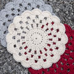 three crocheted doilies are laying on the ground