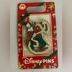 a disney pin with a christmas scene on it