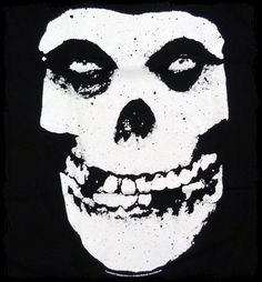 a white skull with black eyes on a black background