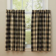 black and white checkered curtains hanging in front of a window