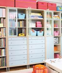 a child's room with lots of bookshelves and toys