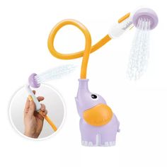 an orange and purple toothbrush holder attached to a yellow plastic elephant with white teeth