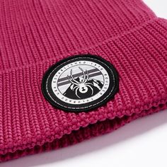 A custom Spyder logo patch adorns this simplistic polyester rolled cuff beanie which is at home on the playground or the ski mountain. Cotton Beanie With Logo Patch, Winter Cotton Beanie With Logo Patch, Winter Cotton Hats With Logo Patch, Sporty Beanie For Outdoor, Sporty Outdoor Beanie Hat, Winter Outdoor Beanie With Logo Patch, Casual Outdoor Hat With Custom Logo, Pink Outdoor Beanie Cap, Pink Beanie For Outdoor