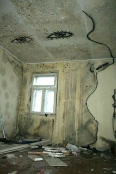 an unfinished room with graffiti on the walls and ceiling, along with debris scattered about