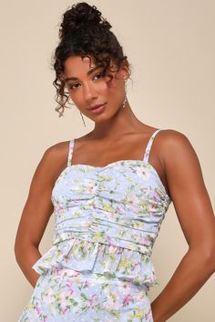 A cute OOTD like the Lulus Easily Beloved Light Blue Floral Ruched Ruffled Sleeveless Top is all you need to impress at your next event! Lightweight woven fabric, with a charming floral print and a burnout dotted design, shapes adjustable spaghetti straps and a subtle V-neckline. Ruched across the bodice lends a flattering effect, finishing with a cropped and ruffled hem. Exposed silver zipper at back. Pair with the matching skirt for a complete look! Fit: This garment fits true to size. Length: Fitted Tops With Ruched Bodice For Spring, Spring Party Tops With Smocked Back, Fitted Summer Top With Ruched Bodice, Summer Fitted Tops With Ruched Bodice, Summer Tops With Ruched Bodice, Fitted Tops With Ruched Bodice For Summer, Fitted Sleeveless Top With Smocked Back, Spring Camisole Dress With Ruffles, Chic Summer Tank Top With Sweetheart Neckline