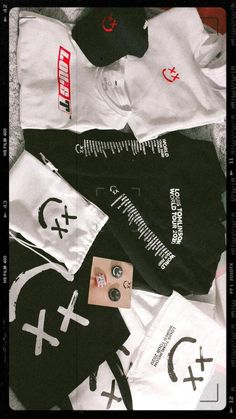 various t - shirts and caps are laid out on the floor with tags attached to them