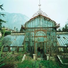 an old greenhouse with lots of glass in it