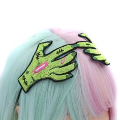 "Elevate your style with our Zombie Hands Headband. This unique accessory features two zombie hands clasping over the top of your head, with wired fingers that can be shaped to suit your mood. The design is brought to life with high-quality machine embroidery, a creation made and digitized by me. The elastic cord is securely sewn on, ensuring a comfortable and secure fit. Whether you're a fan of the undead aesthetic or simply love distinctive accessories, this headband adds an edgy and artistic touch to your look. Stand out from the crowd with this uniquely crafted headpiece that combines craftsmanship and creativity, making it a perfect addition to your collection of standout accessories. ♥ Measures approx. 6.5\" across x 3\" high ♥ Designed by & exclusive to Kawaii Hair Candy ♥ Made in t Undead Aesthetic, Zombie Hair, Zombie Hands, Mode Rockabilly, Kawaii Hair Clips, 21st Birthday Outfit, Kawaii Hair, Zombie Hand, Goth Clothing