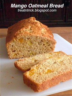 a loaf of mango oatmeal bread sitting on top of a cutting board