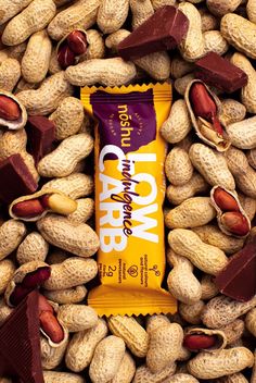 a chocolate bar surrounded by peanuts and other nuts