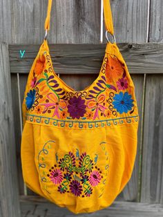 "Super Cute Floral Embroidered Bag from Puebla, Mexico Overview *Thread material * Cotton Fabric *approximate measurements: 13\" from bottom to zipper area & 15-16 with if expanded *handmade *Design colors may vary per purse as all are embroidered with unique colors * Closure is zipper or magnetic button - you can specify in notes section @ checkout which one you prefer * One pocket inside Care *hand wash only *delicate care *hang dry Please email me your questions before buying. All of my i Multicolor Embroidered Hobo Bag For Everyday Use, Embroidered Satchel Hobo Bag For Daily Use, Embroidered Hobo Tote Bag For Festival, Floral Embroidered Tote Shoulder Bag For Festival, Festival Embroidered Tote Bags, Yellow Embroidered Travel Bag, Bohemian Cotton Bag With Floral Embroidery, Yellow Embroidered Tote Bag, Bohemian Cotton Bags With Floral Embroidery