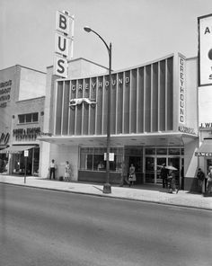 an old black and white photo of people standing in front of a building