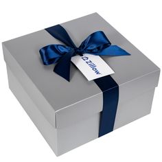 a silver box with a blue ribbon and a tag on it