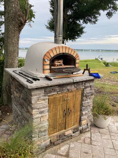 an outdoor pizza oven with tools on it