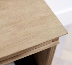 a close up view of a wooden table with two drawers on each side and one drawer open