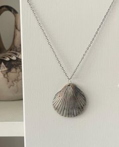 This is a Atlantic bay scallop shell that I foraged on the outer banks. It is pierced and bejeweled with silver wire to highlight the natural contours of the shell. Silver Shell-shaped Ocean-inspired Jewelry, Silver Shell-shaped Jewelry, Trendy Silver Shell Jewelry With Oyster Bracelet, Handmade Silver Shell Jewelry, Silver Ocean-inspired Wire Wrapped Jewelry, Silver Wire Wrapped Ocean-inspired Jewelry, Silver Wire Wrapped Ocean-themed Jewelry, Handmade Silver Shell Necklace, Silver Shell-shaped Bohemian Necklace