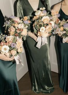 three bridesmaids in green dresses holding bouquets