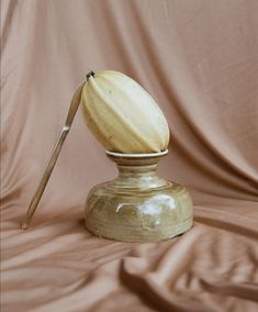 an old fashioned wooden object with a knife sticking out of it's center piece