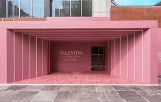 a pink building with an entrance that says valemino