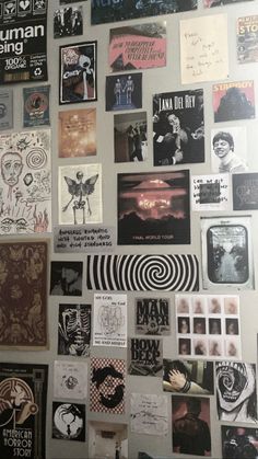 the wall is covered with posters and stickers