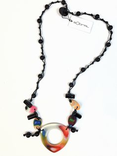 This necklace is part of the retired Tropicalia line and is called Taiza. This necklace features a tropical colored main pendant with 3 small dangling pendants on a black cord of hand knotted black and blue beads. The length is 30" not including the pendants.  The first United Nations Conference to address environmental degradation was held in Stockholm in 1972. Already at that time the designer Carlos Sobral was working with resin and creating new techniques and alternative products to reuse al Environmental Degradation, Earring Cards, Reddish Brown, United Nations, Fabric Jewelry, Blue Beads, Jewelry Pouch, Black Beads, Precious Stones