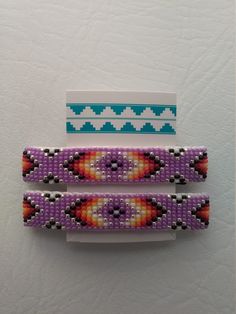 two pieces of beaded bracelets sitting next to each other