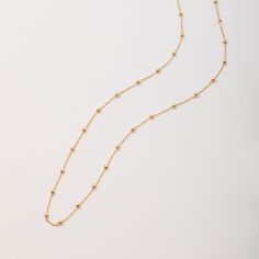 🌟 Elevate your style with our 14k solid gold satellite beaded ball chain necklace. This delicate and minimalist necklace features evenly spaced gold beads, making it perfect for layering or wearing alone. Ideal for everyday wear and special occasions, this timeless piece adds a touch of sophistication to any outfit. Perfect for birthdays, anniversaries, or just because. ✨ Perfect For:     Birthdays 🎉     Anniversaries 💕     Everyday Elegance 🌼 Order now to add a versatile and elegant piece to your jewelry collection! Material: Solid Gold (Not Gold Filled or Gold Plated) Gold Karat: 14 K Gold (585) Bead ball size: 1.8 mm, 2.0 mm Abundant Bead Ball Necklace; Ball size: 1.8mm Rare Bead Necklace; Ball size: 2.0mm You can customize the necklace length from 14 to 20 inches. Teen (Petite): 6. Minimalist Yellow Gold Necklace With Beaded Chain, Minimalist Single Strand 14k Gold Filled Necklace, Minimalist Everyday Single Strand Chain Necklace, Minimalist Everyday Chain Necklace With Round Beads, Minimalist 14k Gold Filled Single Strand Necklace, Everyday Minimalist Chain Necklace With Round Beads, Everyday Minimalist Round Beads Chain Necklace, Minimalist 14k Gold Filled Round Bead Necklaces, Minimalist Ball Chain Necklace