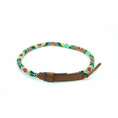 a brown leather bracelet with multicolored braiding