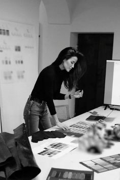 a woman looking at pictures on a table