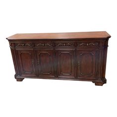 an old wooden sideboard with carvings on the top and bottom, against a white background