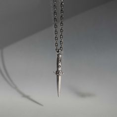 Switchblade charm necklace in sterling silverChain length = 18" ~ 24"Pendant height = 31mmSterling SilverHandmade in NYC Luxury Hand Forged Silver Jewelry, Luxury Hand Forged Sterling Silver Necklace, Edgy Silver Metal Necklace, Punk Necklace With Adjustable Chain, Adjustable Punk Stainless Steel Necklace, Necklace Knives, Blade Necklace, Clothes Board, Skull Necklace