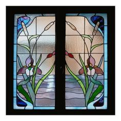 two stained glass windows with flowers in them