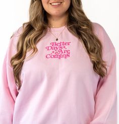 Whatever you're going through, just know there are better days ahead. This sweater is a great reminder of that. Featuring a retro embroidered font with the saying "Better Days Ahead" in hot pink across the center chest. This crewneck sweater has a slightly lighter exterior and runs a tad bit boxier and wider with stretch. For a fully loose oversized look, size up. This item is made to order in our shop so please allow up to one week processing time (we usually take less than that though). Detail Pink Cotton Sweater With Text Print, Pink Text Print Sweatshirt For Loungewear, Pink Long Sleeve Sweater With Slogan, Pink Cotton Sweater With Slogan, Long Sleeve Pink Sweater With Slogan, Pink Slogan Sweatshirt For Spring, Pink Slogan Sweatshirt For Loungewear, Pink Spring Sweatshirt With Slogan, Spring Pink Sweatshirt With Slogan