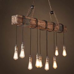 a light fixture made out of wooden planks and hanging from it's sides