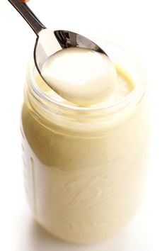 a spoon in a jar filled with cream