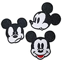 three mickey mouse patches with faces on them