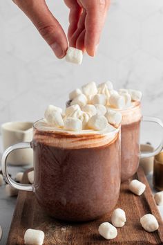 two mugs filled with hot chocolate and marshmallows