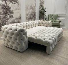 a large white couch sitting on top of a hard wood floor