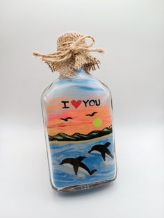 a glass bottle with an i love you message painted on it