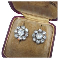 Antique rose cut diamond earrings in floral design with large rose cut diamonds with a total estimate diamond weight of 11 carats center stone diameter 7.30mm/ smaller stone diameter 5.30mm and earing head diameter 15.70 mm back foiled old technique 10k gold setting excellent diamond spark with earrings head diameter of 1.5 cm and earrings length of 2.5 cm dates back to 1850.c victorian era Diamond Gold Earrings, Daisy Earrings, Antique Roses, Diamond Gold, Victorian Jewelry, Rose Cut Diamond, Gold Set, Precious Gemstones, Design Floral