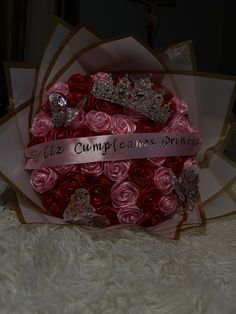 a bouquet of roses with tiaras on it