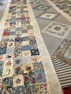 an old quilt is laying on the floor