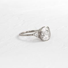 an oval diamond ring with three diamonds on the side